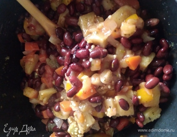 Перемешать рагу с фасолью и чесноком. Готовить вместе еще 5–7 минут.