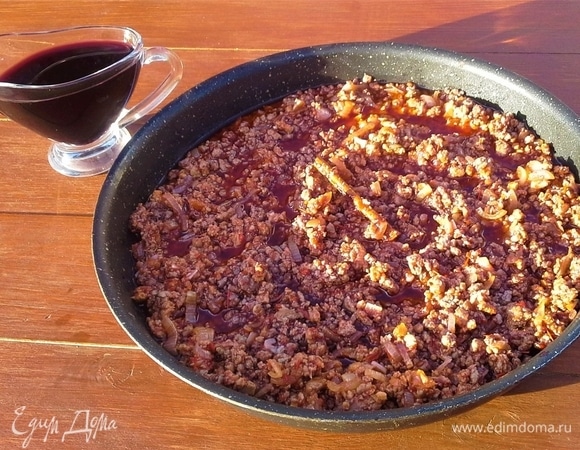 Баклажаны посыпать солью с двух сторон и отложить в сторону на 20 минут. В это время обжариваю лук с чесноком на оливковом масле, добавляю фарш. Несколько минут обжариваю, солю, кладу палочку корицы, томатное пюре и добавляю вино. Тушу под крышкой.