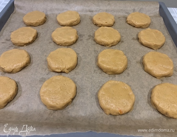 Выложите тесто на противень, застеленный пергаментной бумагой, в виде небольших шариков. Оставьте расстояние между печеньками, так как при выпекании они расползаются.