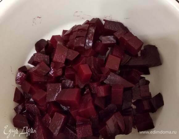 Свеклу нарезаем кубиками. К ней добавляем заправку. Перемешиваем свеклу с заправкой и оставляем на 10 минут. Это нужно для того, чтобы свекла меньше окрашивала остальные ингредиенты.