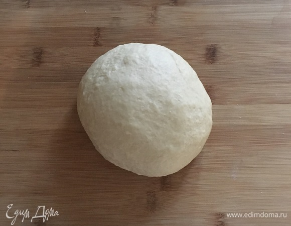 Когда тесто соберется в однородный шар, вмешать частями размягченное сливочное масло, каждый раз очень хорошо вымешивая. Вымешивать тесто 10–15 минут, до гладкого состояния. Затем убрать тесто в миску, смазанную маслом, накрыть пленкой и оставить в теплом месте на 1,5 часа.