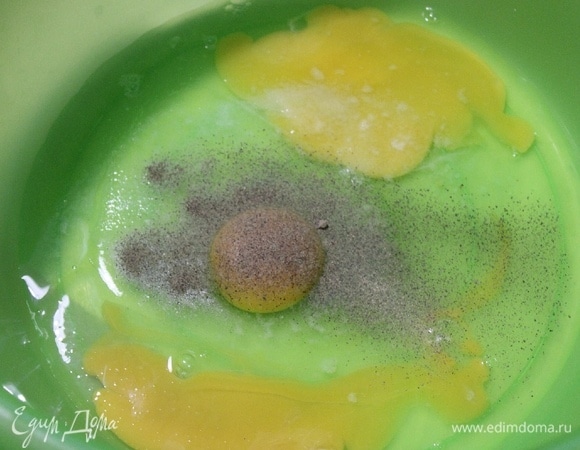 В миску разбить яйца, добавить соль и черный перец, взбить вечником.