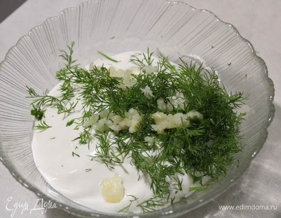 В миску выложить сметану, нашинковать укроп и пропустить чеснок через пресс, перемешать.