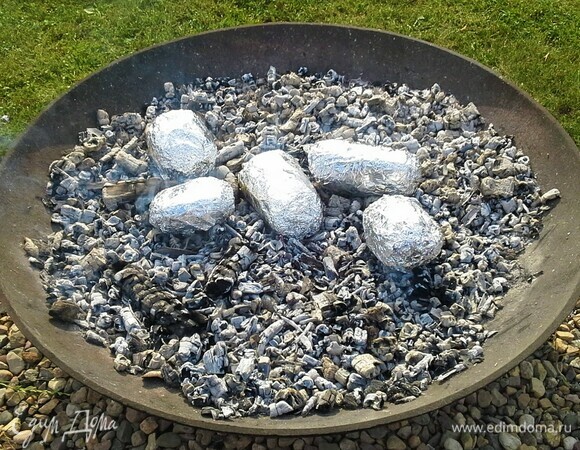 Запекаем картофель, закопав его в угли. Углей должно быть много — картошка должна быть полностью покрыта ими.