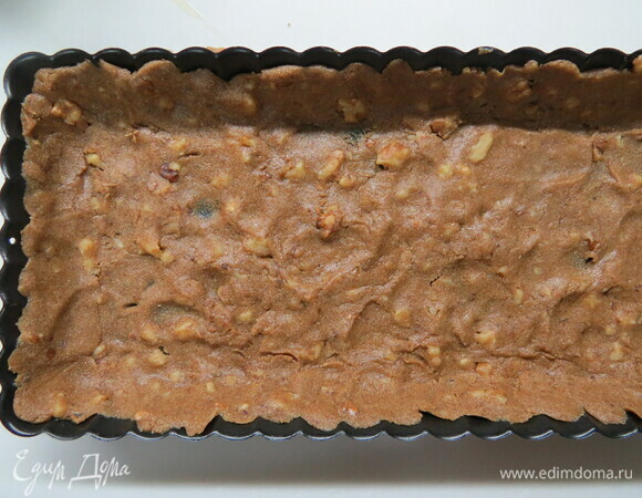 Выложить его в форму для выпечки, формирую дно и бортики. Тесто будет слегка липким, но его очень удобно и легко укладывать мокрыми руками. Отправить форму с тестом в холодильник на 10 минут.