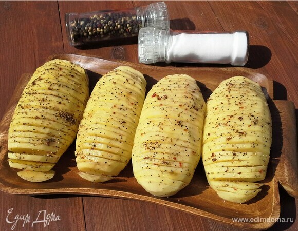Картофель посолить, поперчить смесью перцев из мельницы, посыпать сухим чесночным порошком.