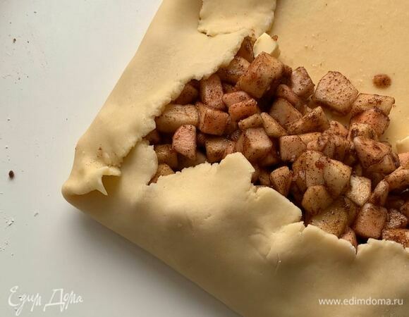 Затем выложите яблоки на тесто и заверните рулет.