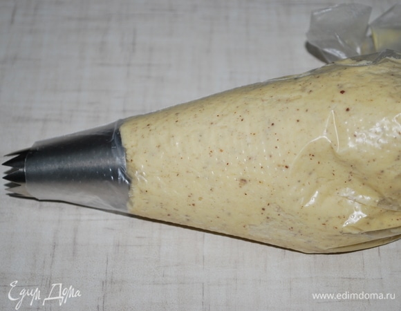 Выложить тесто в кондитерский мешок с насадкой «открытая звезда».