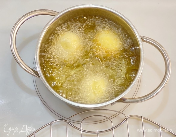 В кастрюлю с толстым дном налить растительное масло (примерно на 2,5–3 см). Нагреть до 180°C. Аккуратно закидываем по несколько шариков и обжариваем до золотистости, постоянно их переворачивая, чтобы они лучше прожарились. Готовые шарики выложить на бумажные полотенца. У вас получатся вкусные шарики — с хрустящей корочкой, нежные и творожные внутри. Обязательно приготовьте! Несмотря на то, что жарят их в масле, они получаются совсем не жирными.