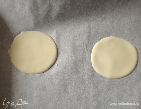 Противень застелить пергаментной бумагой. Сверху выложить ложку теста и обратной стороной распределить его как можно тоньше — так, чтобы получился круг диаметром 10 см без пузырей и дырочек.