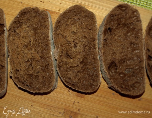 У меня ржаная чиабатта. Хлеб подсушить на сковороде. Печень трески выкладываем на бумажные полотенца, чтобы удалить лишнее масло. Лук нарезать тонкими кольцами. Помидоры черри разрезать на несколько частей.