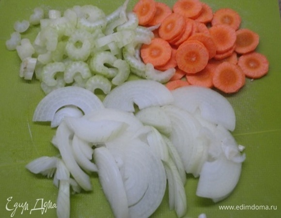 Фасоль замочить в холодной воде на несколько часов, затем поставить вариться до готовности. Репчатый лук нарезать полукольцами, морковь — кружочками, сельдерей — брусочками.