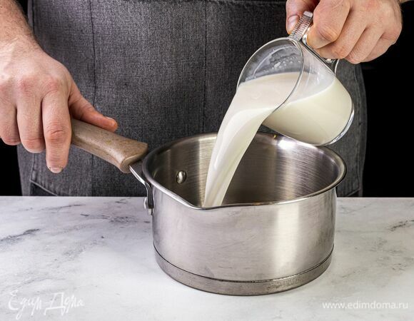 Подогрейте молоко в сотейнике.
