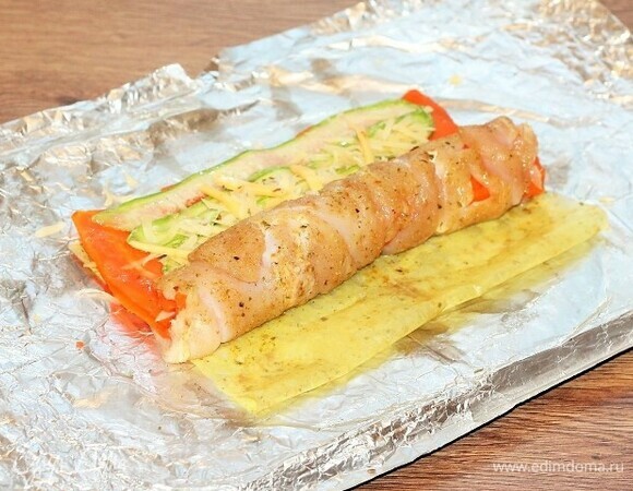 Сворачиваем курицу с овощами в рулет.