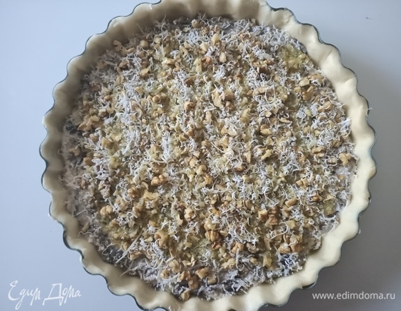 Выложить начинку, разровнять. Сверху посыпать рублеными грецкими орехами и пармезаном. Полить оливковым маслом и отправить в предварительно разогретую до 180°C вентилируемую духовку на 35–40 минут.