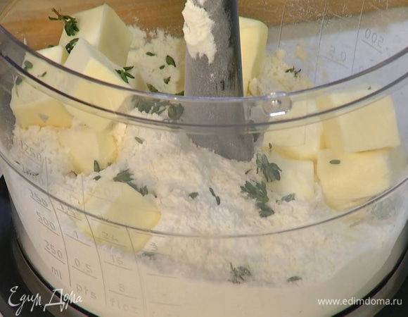 Просеянную муку и щепотку соли всыпать в чашу комбайна, добавить нарезанное масло, листья тимьяна и вымешать, затем влить 2 ст. ложки ледяной воды и еще раз вымешать.