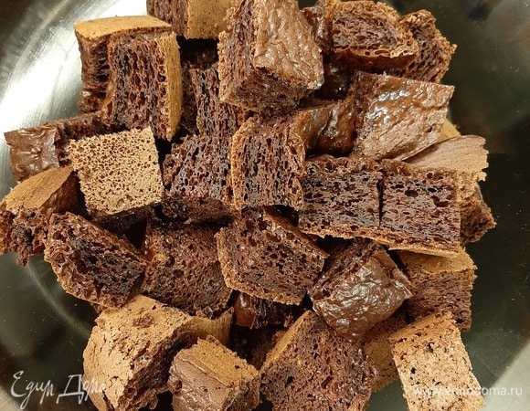 Когда коржи остынут, произвольно нарезать их на кубики. Кубики окунуть в сметанный крем и выложить в чашу. Готовим сам крем: сметану взбить с сахаром до увеличения массы в объеме и загустения (лучше брать сметану жирностью 20 % и выше).