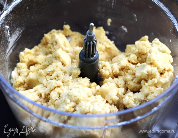 Коржи. Сливочное масло нарезать кусками. Смешать сухие ингредиенты. Положить в комбайн все сухие ингредиенты, добавить яйцо и желток, все вместе собрать винтовой насадкой, постепенно добавляя кусочки масла. Стараться сделать это быстро, чтобы тесто не перегревалось. Тесто не должно липнуть к рукам. Завернуть тесто в пленку и положить в холодильник на несколько часов, лучше — на ночь.