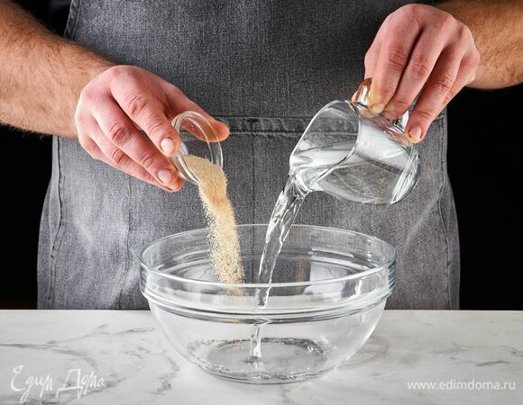 В чаше смешайте сухие дрожжи и теплую воду.