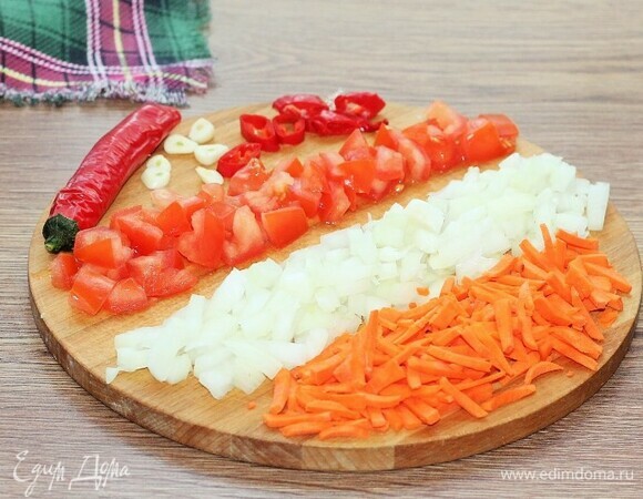 Приготовим соус. Нарезать очищенные овощи: лук — маленькими кубиками, перец — полосками, морковь — соломкой, помидоры — дольками, чеснок — слайсами.