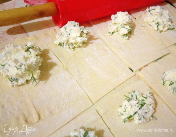 Слоеное тесто раскатываем, разрезаем на прямоугольники, выкладываем начинку и скрепляем края.