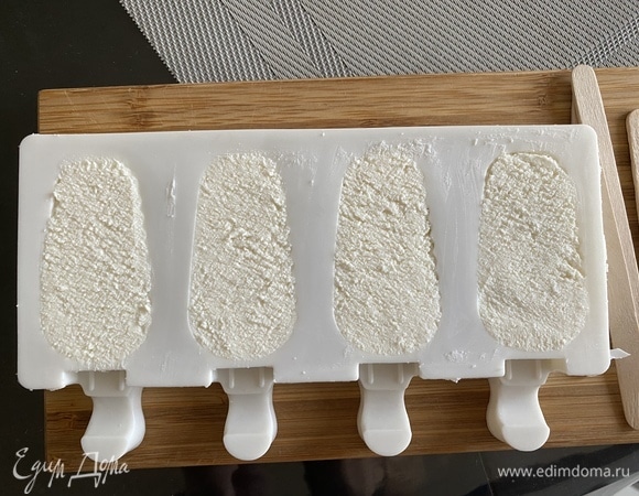Форму для эскимо наполняем творожной массой, хорошо утрамбовывая, вставляем палочки и убираем в морозилку на 2–3 часа, можно больше.