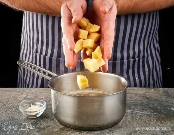 Через 10 минут после закипания воды, выложите в кастрюлю картофель и чесночный порошок.