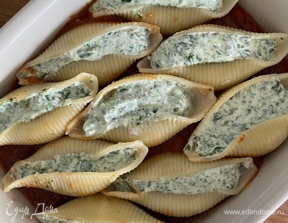 Томатный соус (у меня готовый, с базиликом) выложить на дно формы для запекания. На него в один слой — конкильони. Духовку разогреть до 190°C. Форму накрыть фольгой. Запекать 25 минут. Снять фольгу и еще 10–15 минут запечь. Достать форму, посыпать тертым пармезаном. Подавать в теплом виде. Приятного аппетита!