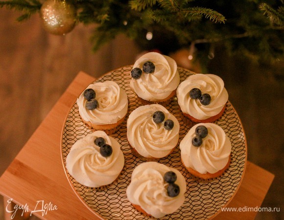 Переложить крем в кондитерский мешок с насадкой и сделать шапочки на капкейках.