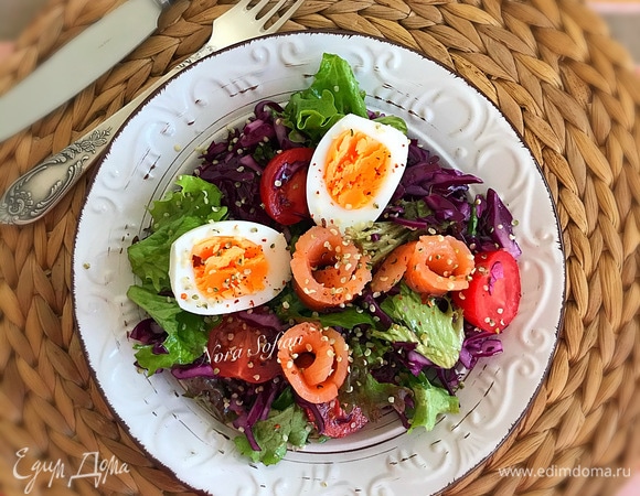 Переложить салат в посуду для подачи. Сверху разложить вареное яйцо и рыбу.