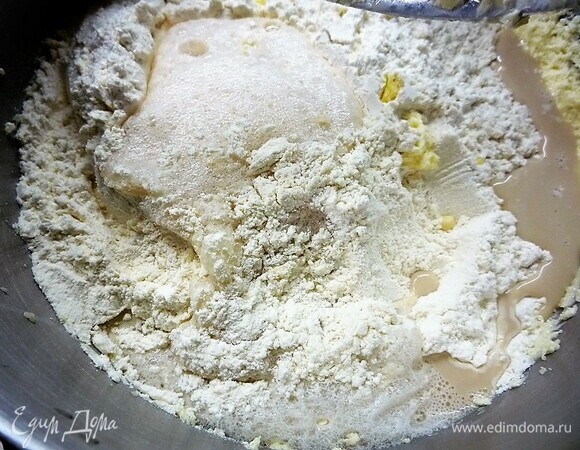 Продолжаем вымешивать и добавляем в массу муку с разрыхлителем, выливаем подошедшие дрожжи.