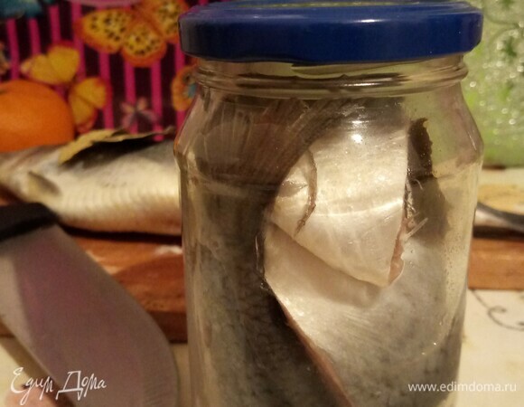Рыбу и специи сложить в чистую стеклянную банку. Объем моей емкости — 450 мл. Важно слегка ее прикрыть, но не закручивать сильно крышку.