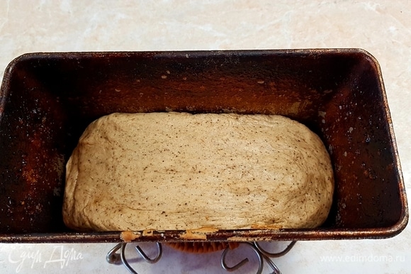 Форму для выпечки хлеба смазать маслом и выложить в нее тесто. Оставить на 20 минут. Потом поставить в духовку, разогретую до 240°C, и выпекать 10 минут. После этого снизить температуру до 200°C и выпекать еще 25 минут.