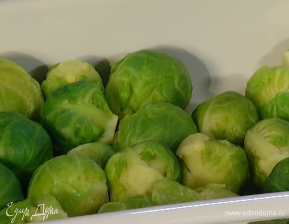 Брюссельскую капусту отварить практически до готовности, затем выложить в жаропрочную форму, полить 2–3 ст. ложками оливкового масла, слегка посолить, поперчить, посыпать грецкими орехами и полить кленовым сиропом.