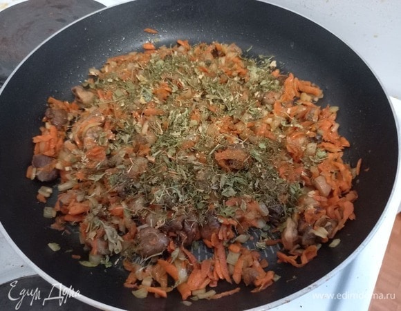 Добавляем сушеные травы: укроп и петрушку, закрываем крышкой и тушим 3 минуты, пока травы не станут мягкими. Если будете использовать свежую зелень, ее нужно будет добавить позже, при замешивании начинки.