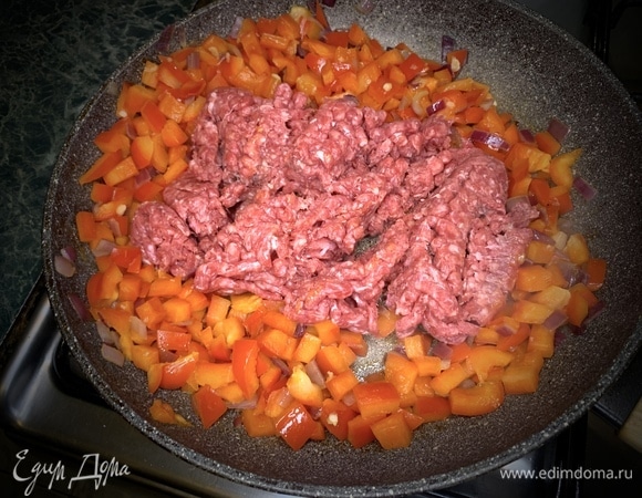 Добавляем фарш, разбиваем комки на мелкие кусочки.