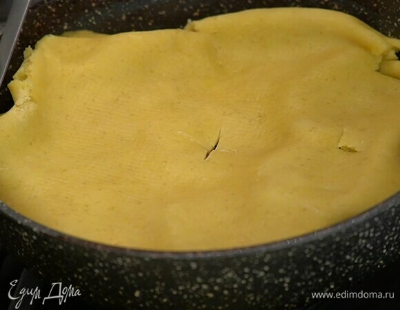 Из сковороды удалить специи, накрыть груши пластом теста, подворачивая края внутрь, в центре теста сделать надрез крестиком.