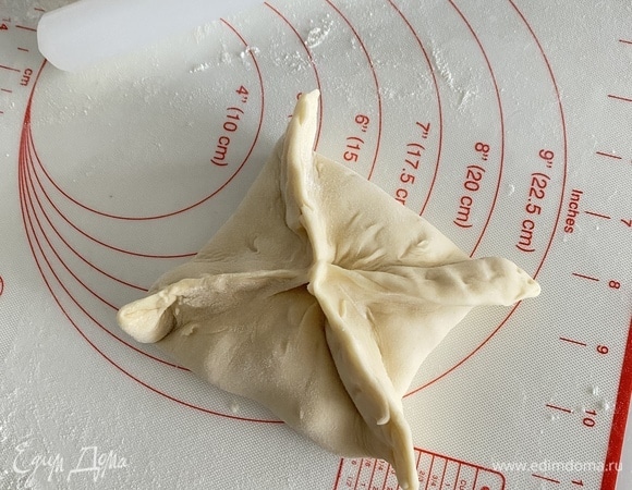 Спустя время тесто разделить на кусочки примерно по 120–130 г, получится шесть кусочков. Каждый раскатать в небольшой круг, в центр положить 2 ст. л. с горкой начинки и защипнуть края в виде конверта.