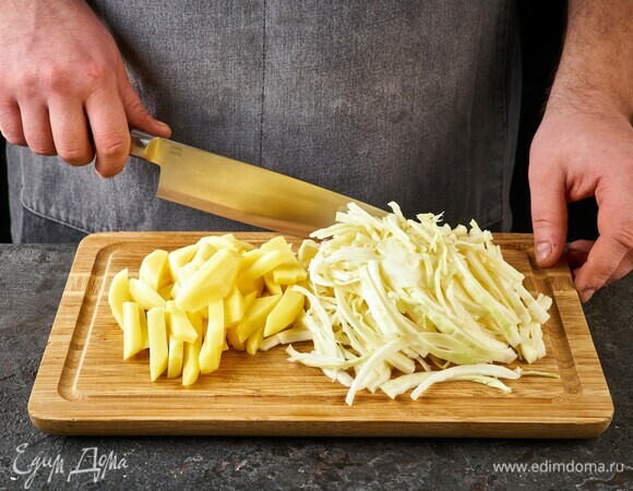 Картофель нарежьте ломтиками, капусту тонко нашинкуйте.