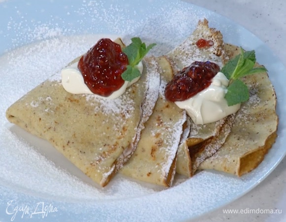 Посыпать блины сахарной пудрой и подавать со взбитыми сливками и джемом, украсив листьями мяты.