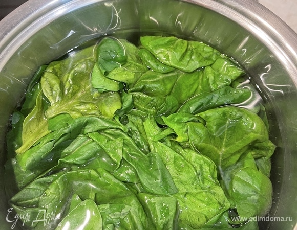 Бланшируем шпинат секунд 15–20, откидываем на дуршлаг под холодную воду, отжимаем. Выкладываем в блендер, добавляем пару ложек молока и пюрируем зелень. Вмешиваем шпинат в тесто и жарим блинчики.