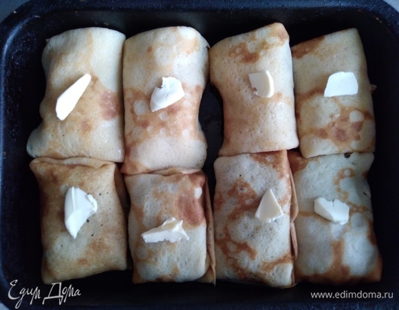 Форму смазать маслом, поместить блинчики, сверху положить немного сливочного масла. Поставить в разогретую до 180°C духовку на 15 минут.