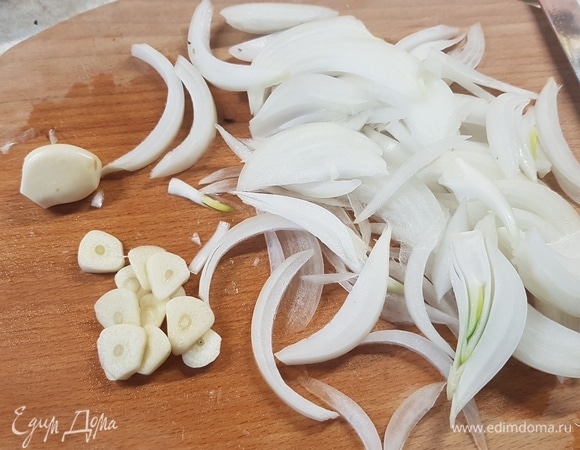 Лук нарезать дольками, чеснок — кружочками.