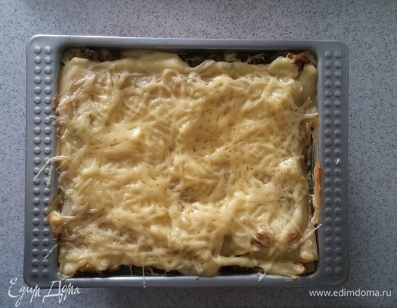 За 5 минут до готовности вынимаем форму с лазаньей из духовки и посыпаем оставшимся сыром, а затем снова ставим в духовку на оставшиеся 5 минут. После чего достаем форму из духовки и раскладываем лазанью по тарелкам. Приятного аппетита!