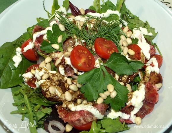 В миске смешиваем ингредиенты для заправки. Можно добавить по желанию в заправку мед. Поливаем полученной заправкой салат. Добавляем сверху кедровые орехи и зелень. Салат готов!