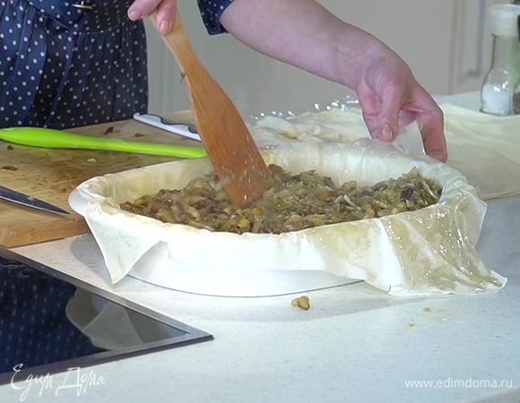 В глубокую продолговатую форму для запекания уложить один на другой три листа фило, промазывая их растопленным маслом, сверху выложить начинку, а затем оставшиеся листы фило, так же смазав их маслом. Уголки теста подвернуть внутрь формы и смазать оставшимся маслом.