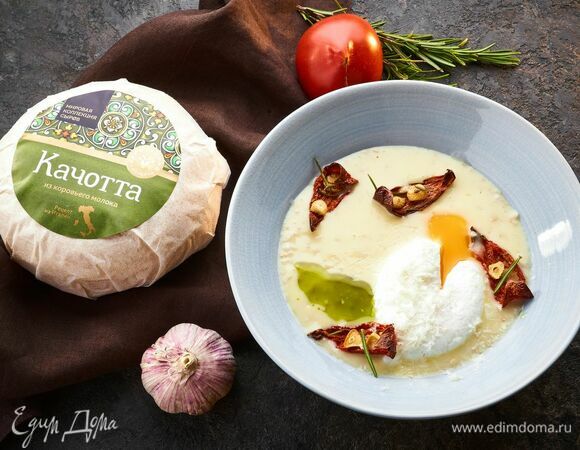 Сервируйте блюдо. На тарелку выложите сырную овсянку, сверху — яйцо пашот и вяленые томаты. По желанию посыпьте еще одной порцией сыра качотта.