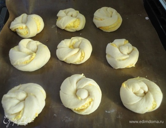 И заворачиваем как узелочки. Выкладываем булочки на пергамент или коврик для выпечки, даем расстояться и выпекаем 20–25 минут при температуре 180°C.