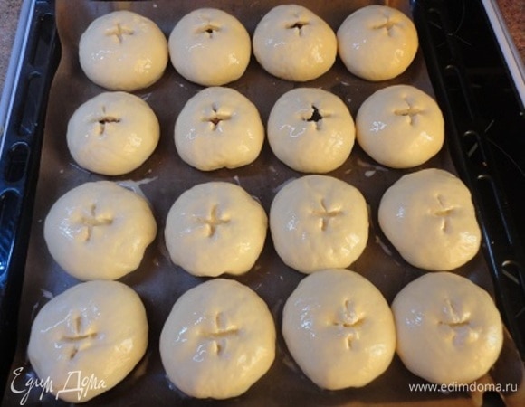 Выложить на противень, застеленный пекарской бумагой. Оставить для подъема. Подошедшие булочки смазать смесью яйца и молока, сверху сделать небольшие насечки ножницами.