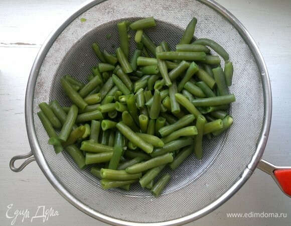 Откинуть фасоль на дуршлаг и поместить под холодную проточную воду, чтобы фасоль как можно быстрее остыла и сохранила цвет.